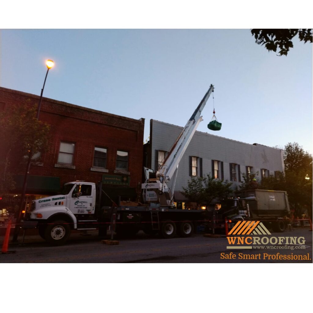 A crane loading material on OP Taylor's roof in Brevard North Carolina