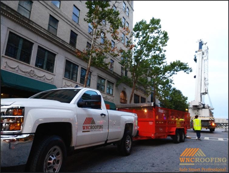 WNC Roofing company pickup truck being unloaded in downtown Asheville, North Carolina