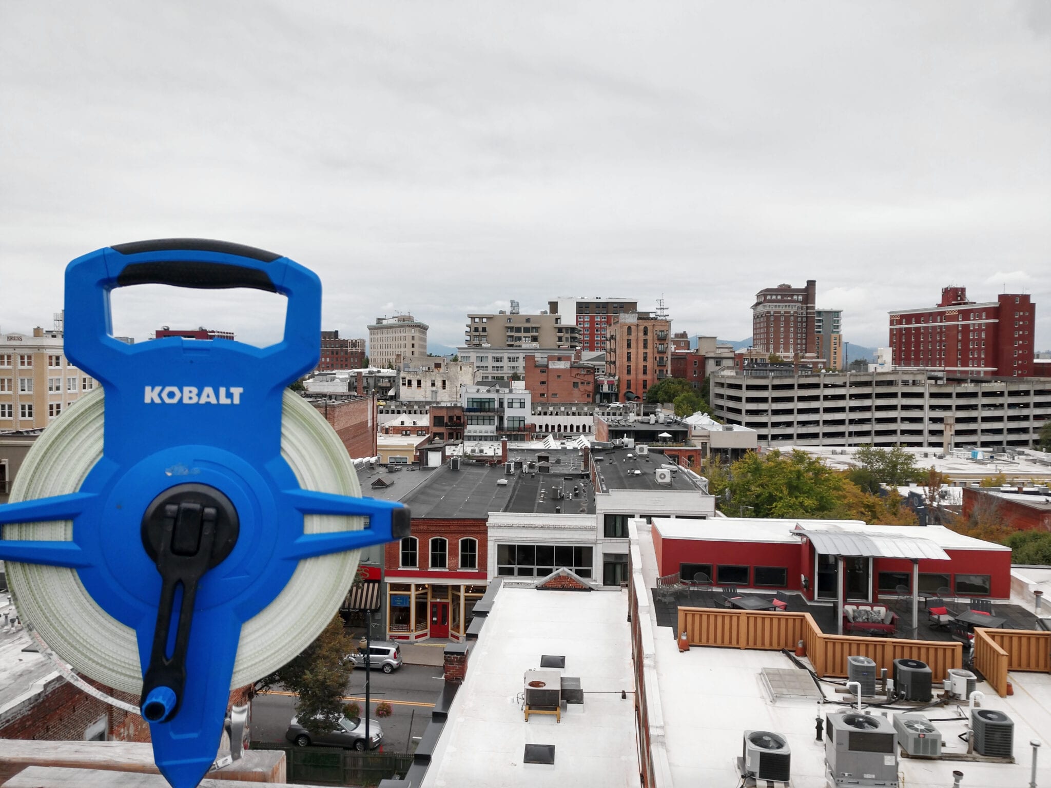 A tape measure and rooftop overlook in busy Downtown Asheville, North Carolina.