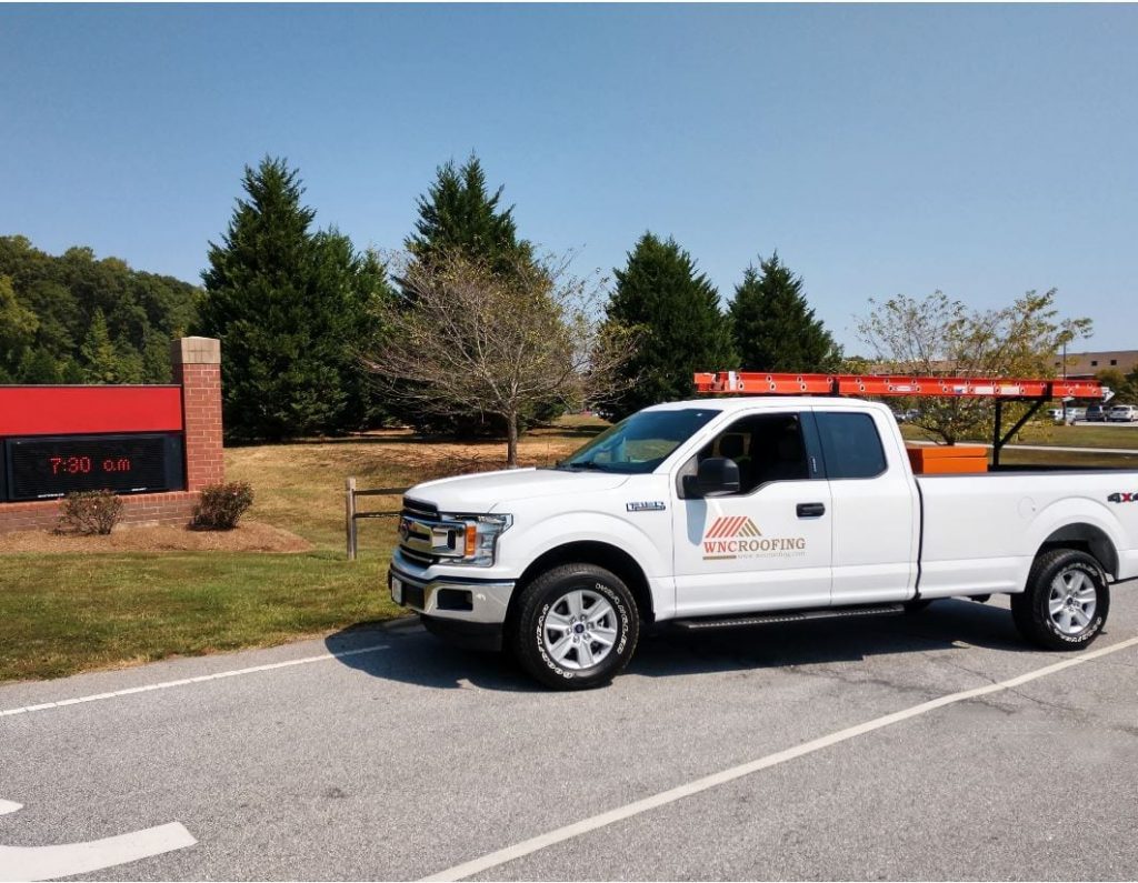 WNC Roofing Ford Truck parked in front of a Middle School in Greenville SC