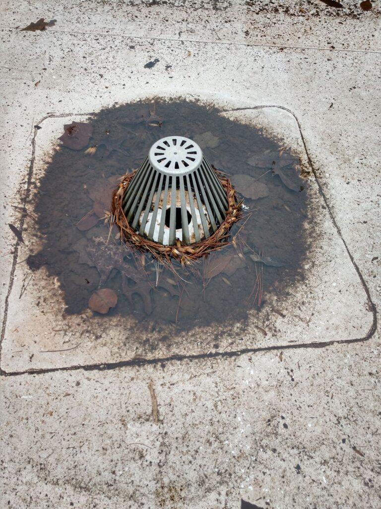 a clogged and stopped up commercial roof drain