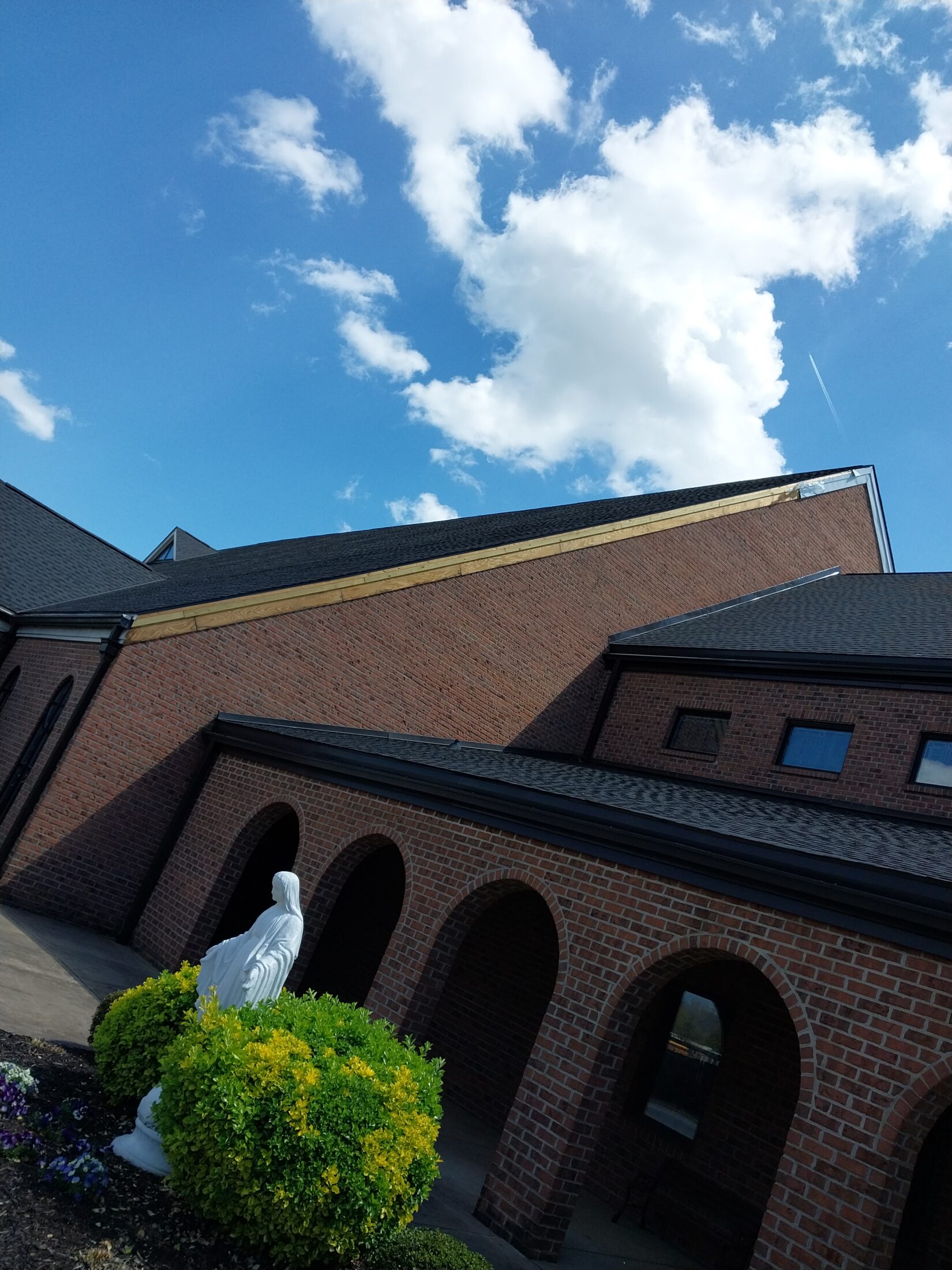 Unfinished metal fascia repair on a church