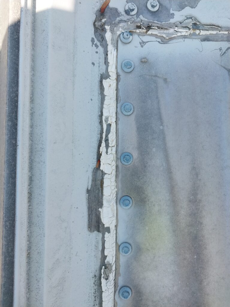Deteriorating sealant on metal roof found during an inspection