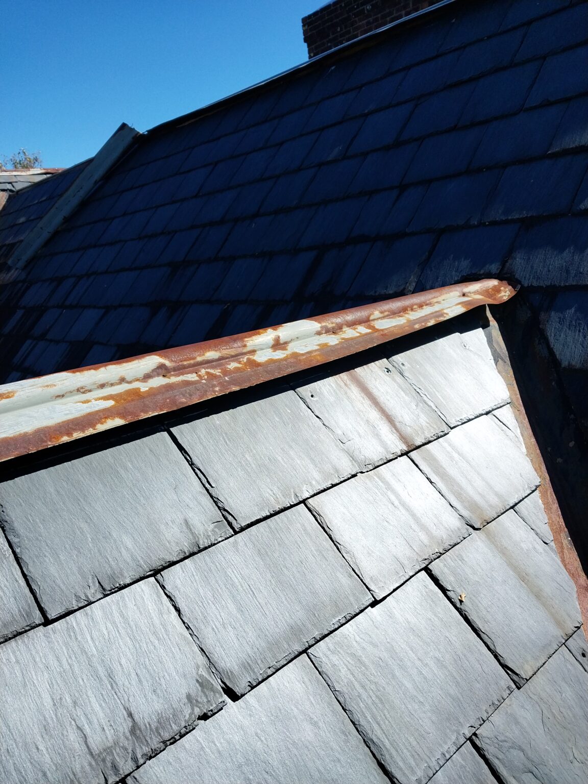 Rusted slate roof cap that needs replacement