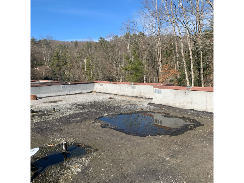 Old built up roof with ponding water