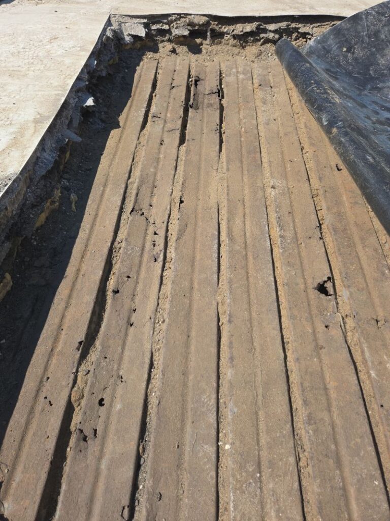 Damaged Roof Decking caused by sealed in moisture from having more that 2 roof layers on it.
