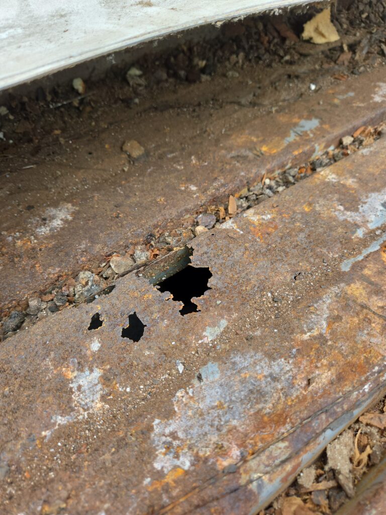 Metal Roof Decking damage that needs to be replaced before putting on a new roof.
