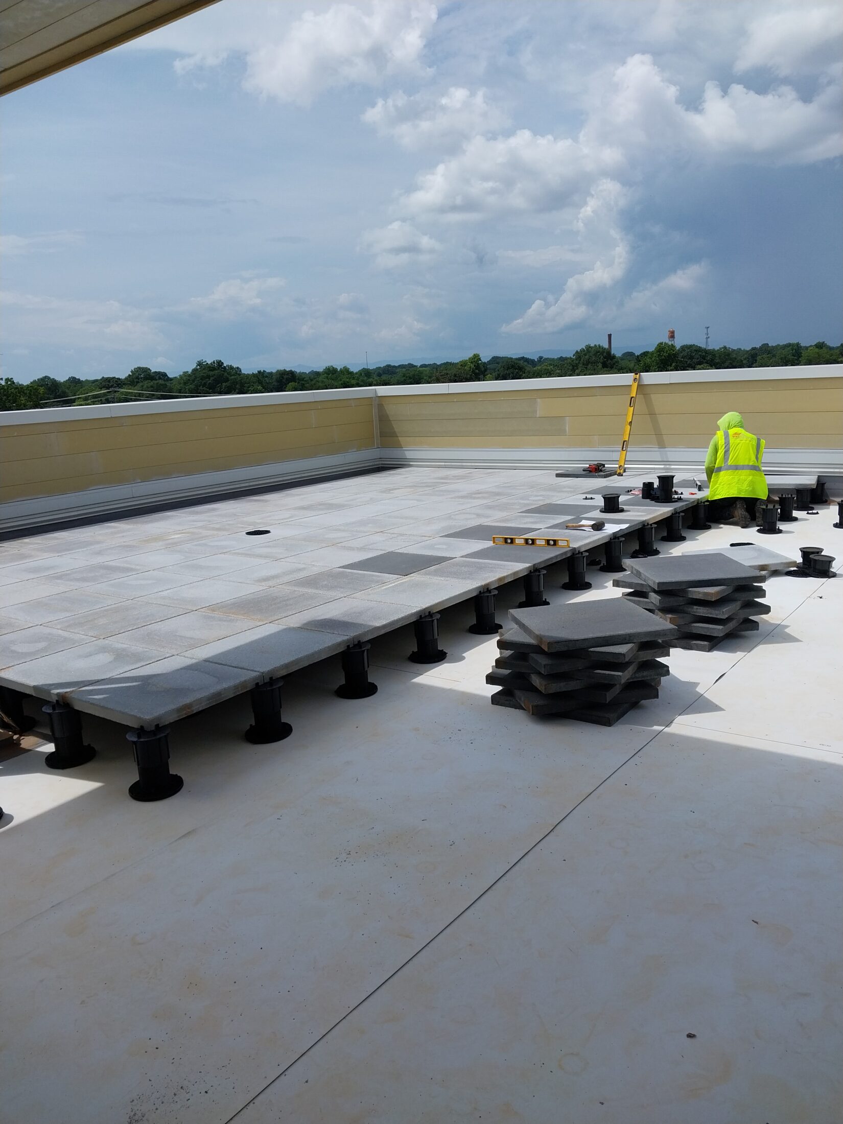 Pedestal paver system install in progress by wnc roofing